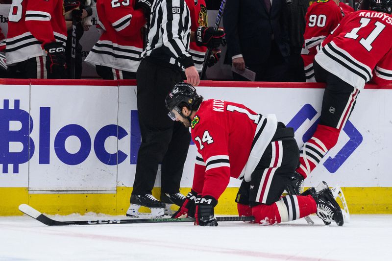 Feb 9, 2024; Chicago, Illinois, USA; Chicago Blackhawks left wing Boris Katchouk (14) crawls off the ice after after losing a skate blade against the New York Rangers during the first period at the United Center. Mandatory Credit: Daniel Bartel-USA TODAY Sports