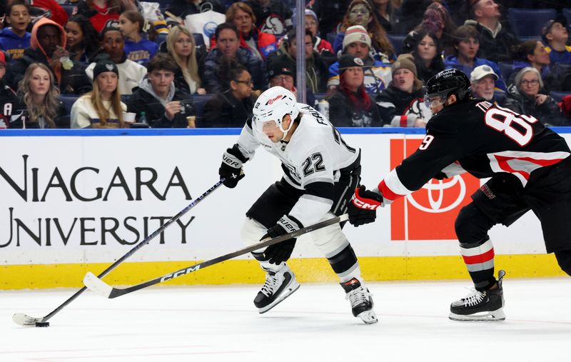 Jan 29, 2026; Buffalo, New York, USA;  Los Angeles Kings left wing Kevin Fiala (22) skates with the puck as Buffalo Sabres right wing Alex Tuch (89) tries to defend during the third period at KeyBank Center. Mandatory Credit: Timothy T. Ludwig-Imagn Images