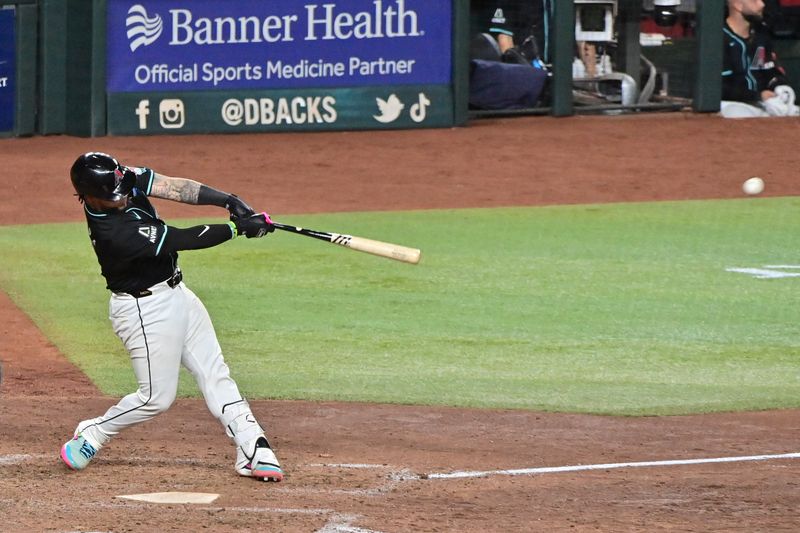 Sep 23, 2024; Phoenix, Arizona, USA;  Arizona Diamondbacks catcher Jose Herrera (11) doubles in the seventh inning against the San Francisco Giants at Chase Field. Mandatory Credit: Matt Kartozian-Imagn Images