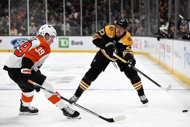 Oct 29, 2024; Boston, Massachusetts, USA; Boston Bruins defenseman Hampus Lindholm (27) passes the puck around Philadelphia Flyers right wing Matvei Michkov (39) during the first period at TD Garden. Mandatory Credit: Brian Fluharty-Imagn Images