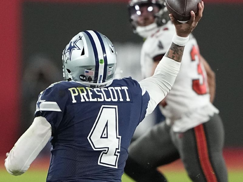 Dallas Cowboys quarterback Dak Prescott (4) gets off a pass as he is brought down by Tampa Bay Buccaneers defensive tackle Rakeem Nunez-Roches (56) during the first half of an NFL wild-card football game, Monday, Jan. 16, 2023, in Tampa, Fla. (AP Photo/Chris Carlson)