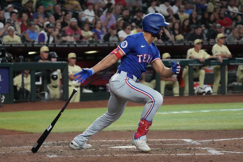 Sep 10, 2024; Phoenix, Arizona, USA; Texas Rangers outfielder Leody Taveras (3) hits against the Arizona Diamondbacks in the seventh inning at Chase Field. Mandatory Credit: Rick Scuteri-Imagn Images