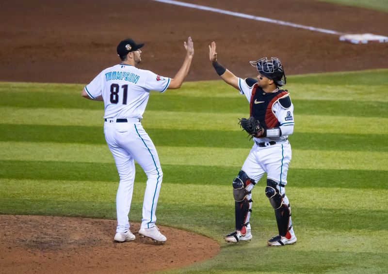 Aug 27, 2023; Phoenix, Arizona, USA; Arizona Diamondbacks pitcher Ryan Thompson (81) celebrates with catcher Gabriel Moreno after defeating the Cincinnati Reds at Chase Field. Mandatory Credit: Mark J. Rebilas-USA TODAY Sports