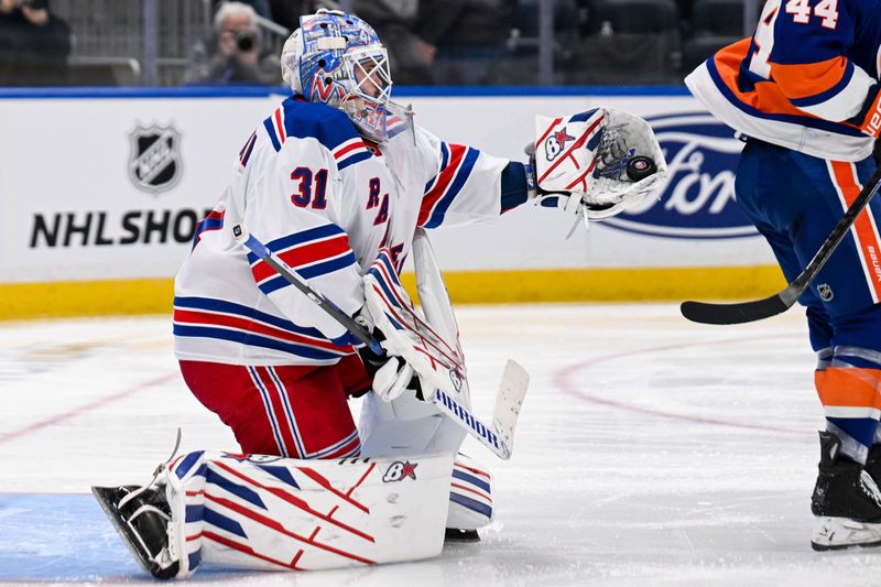 Apr 10, 2025; Elmont, New York, USA;  New York Rangers goaltender Igor Shesterkin (31) makes a glove save against the New York Islanders during the second period at UBS Arena. Mandatory Credit: Dennis Schneidler-Imagn Images