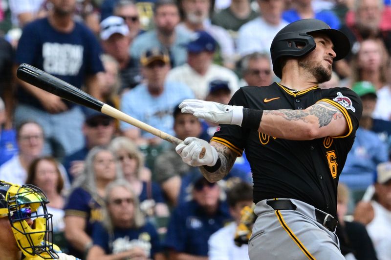 Jul 11, 2024; Milwaukee, Wisconsin, USA; Pittsburgh Pirates catcher Yasmani Grandal (6) hits a double to drive in a run against the Milwaukee Brewers in the seventh inning at American Family Field. Mandatory Credit: Benny Sieu-USA TODAY Sports