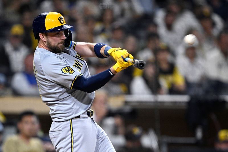 Jun 20, 2024; San Diego, California, USA; Milwaukee Brewers designated hitter Rhys Hoskins (12) hits an RBI double against the San Diego Padres during the ninth inning at Petco Park. Mandatory Credit: Orlando Ramirez-USA TODAY Sports