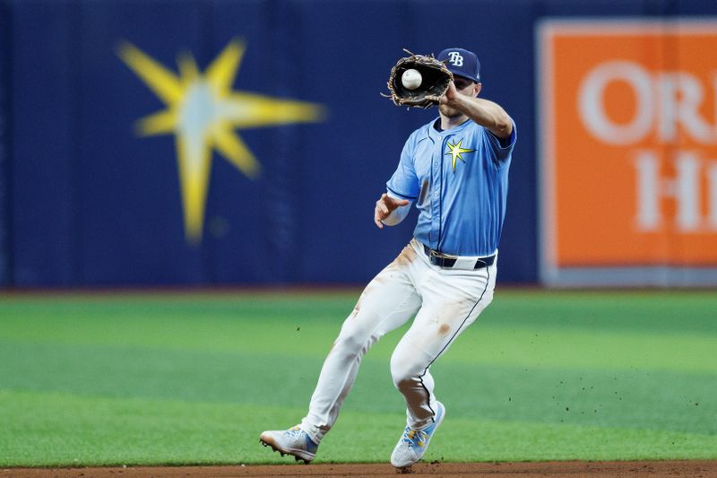 Jun 13, 2024; St. Petersburg, Florida, USA;  Tampa Bay Rays second baseman Brandon Lowe (8) fields the ball for an out against the Chicago Cubs in the ninth inning at Tropicana Field. Mandatory Credit: Nathan Ray Seebeck-USA TODAY Sports