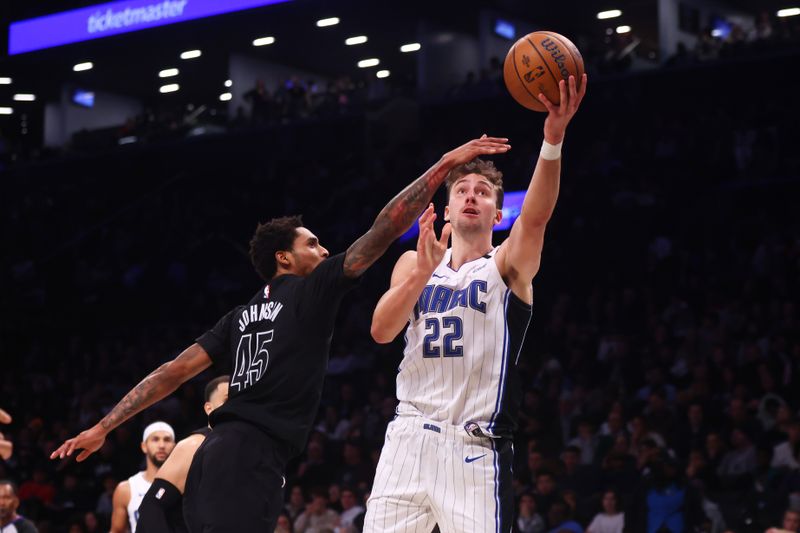 NEW YORK, NEW YORK - NOVEMBER 29: Franz Wagner #22 of the Orlando Magic drives to the basket against Keon Johnson #45 of the Brooklyn Nets during the second half in the Emirates NBA Cup at Barclays Center on November 29, 2024 in New York City. NOTE TO USER: User expressly acknowledges and agrees that, by downloading and or using this Photograph, user is consenting to the terms and conditions of the Getty Images License Agreement. (Photo by Mike Stobe/Getty Images)