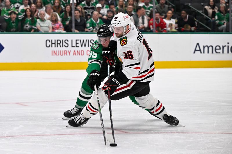 Oct 26, 2024; Dallas, Texas, USA; Dallas Stars defenseman Thomas Harley (55) knocks the puck away from Chicago Blackhawks center Jason Dickinson (16) during the third period at the American Airlines Center. Mandatory Credit: Jerome Miron-Imagn Images