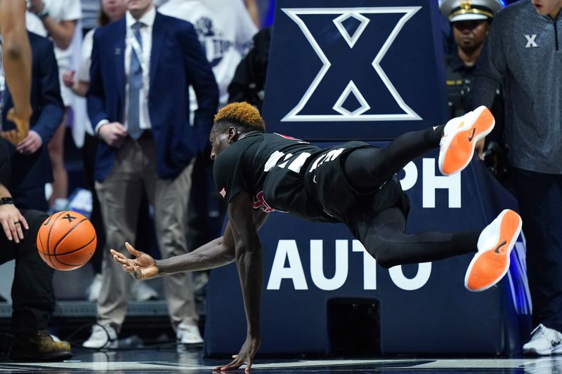 Dec 9, 2023; Cincinnati, Ohio, USA; Cincinnati Bearcats forward Aziz Bandaogo (55) saves the ball from going out of bounds in the first half against the Xavier Musketeers at Cintas Center. Mandatory Credit: Kareem Elgazzar-USA TODAY Sports