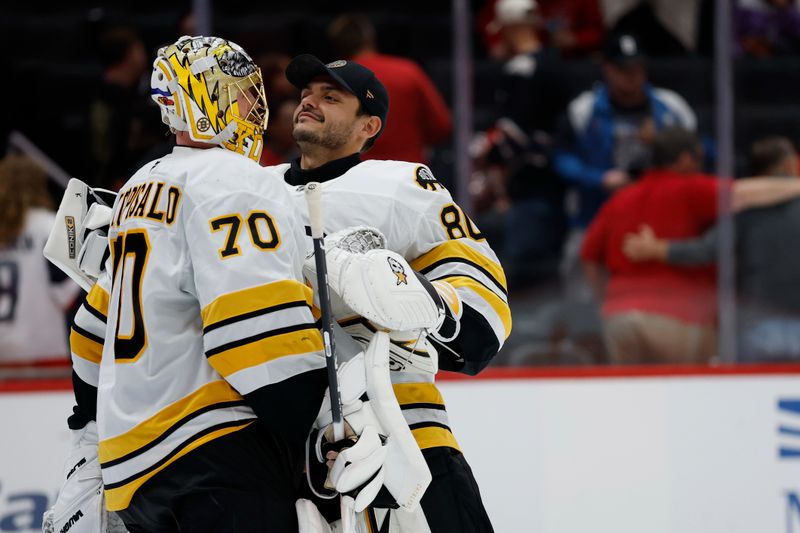 Oct 2, 2025; Washington, District of Columbia, USA; Boston Bruins goaltender Joonas Korpisalo (70) celebrates with Bruins goaltender Michael DiPietro (80) after their game against the Washington Capitals at Capital One Arena. Mandatory Credit: Geoff Burke-Imagn Images