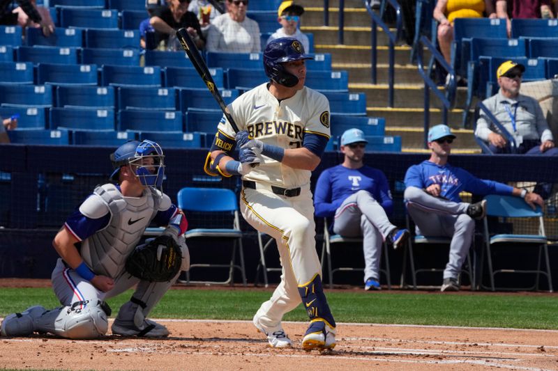 Mar 16, 2024; Phoenix, Arizona, USA; Milwaukee Brewers left fielder Christian Yelich (22) hits a single against the Texas Rangers in the first inning at American Family Fields of Phoenix. Mandatory Credit: Rick Scuteri-USA TODAY Sports