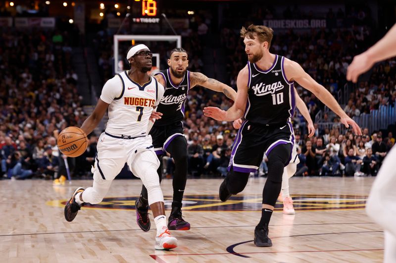 DENVER, COLORADO - FEBRUARY 28: Reggie Jackson #7 of the Denver Nuggets brings the ball up court against Domantas Sabonis #10 and Chris Duarte #3 of the Sacramento Kings against the Sacramento Kings at Ball Arena on February 28, 2024 in Denver, Colorado. NOTE TO USER: User expressly acknowledges and agrees that, by downloading and or using this photograph, User is consenting to the terms and conditions of the Getty Images License Agreement. (Photo by Brendall O'Banon/Clarkson Creative/Getty Images)