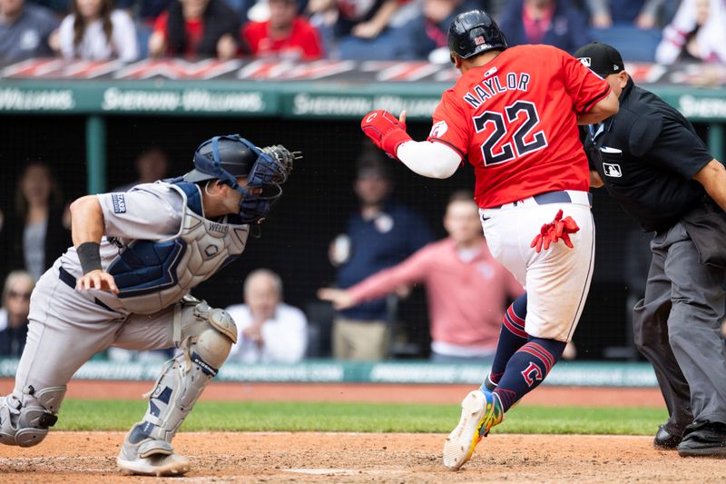 Apr 14, 2024; Cleveland, Ohio, USA; Cleveland Guardians designated hitter Josh Naylor (22) crosses the plate beating the tag by New York Yankees catcher Austin Wells (28) during the tenth inning at Progressive Field. Mandatory Credit: Scott Galvin-USA TODAY Sports