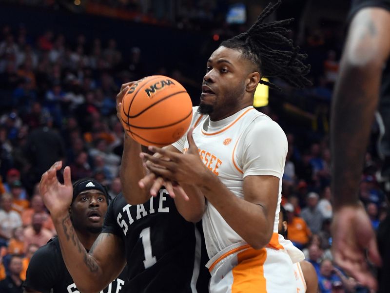 Mar 15, 2024; Nashville, TN, USA; Tennessee Volunteers forward Jonas Aidoo (0) grabs a rebound against Mississippi State Bulldogs forward Tolu Smith (1) during the first half at Bridgestone Arena. Mandatory Credit: Christopher Hanewinckel-USA TODAY Sports