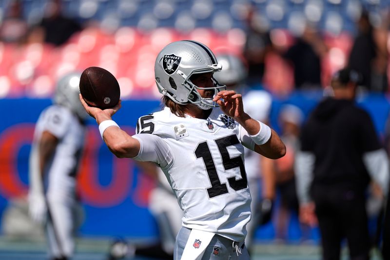 Las Vegas Raiders quarterback Gardner Minshew throws during pregame of an NFL football game against the Denver Broncos, Sunday, Oct. 6, 2024, in Denver. (AP Photo/David Zalubowski)