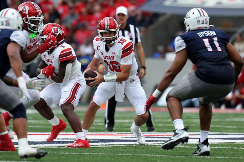 Nov 18, 2023; Tucson, Arizona, USA; Utah Utes quarterback Bryson Barnes (16) runs the ball against Arizona Wildcats linebacker Taylor Upshaw (11) during the first half at Arizona Stadium. Mandatory Credit: Zachary BonDurant-USA TODAY Sports