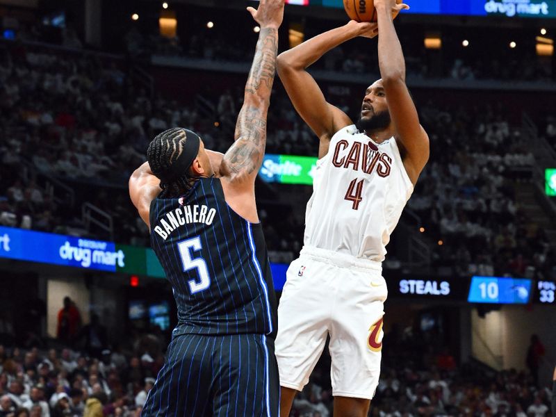 CLEVELAND, OHIO - APRIL 20: Evan Mobley #4 of the Cleveland Cavaliers shoots over Paolo Banchero #5 of the Orlando Magic during the third quarter of game one of the Eastern Conference First Round Playoffs at Rocket Mortgage Fieldhouse on April 20, 2024 in Cleveland, Ohio. The Cavaliers defeated the Magic 97-83. NOTE TO USER: User expressly acknowledges and agrees that, by downloading and or using this photograph, User is consenting to the terms and conditions of the Getty Images License Agreement. (Photo by Jason Miller/Getty Images)