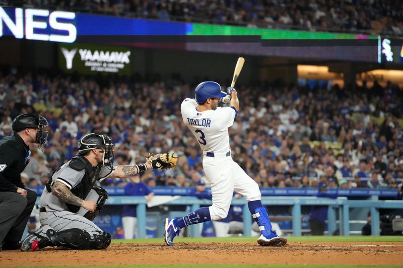 Jun 15, 2023; Los Angeles, California, USA; Los Angeles Dodgers third baseman Chris Taylor (3) follows through on a grand slam home run in the sixth inning as Chicago White Sox catcher Yasmani Grandal (24) watches at Dodger Stadium. Mandatory Credit: Kirby Lee-USA TODAY Sports