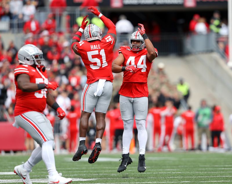 Oct 7, 2023; Columbus, Ohio, USA;  Ohio State Buckeyes defensive end JT Tuimoloau (44) and defensive tackle Michael Hall Jr. (51) celebrate the fourth down stop during the first quarter against the Maryland Terrapins at Ohio Stadium. Mandatory Credit: Joseph Maiorana-USA TODAY Sports