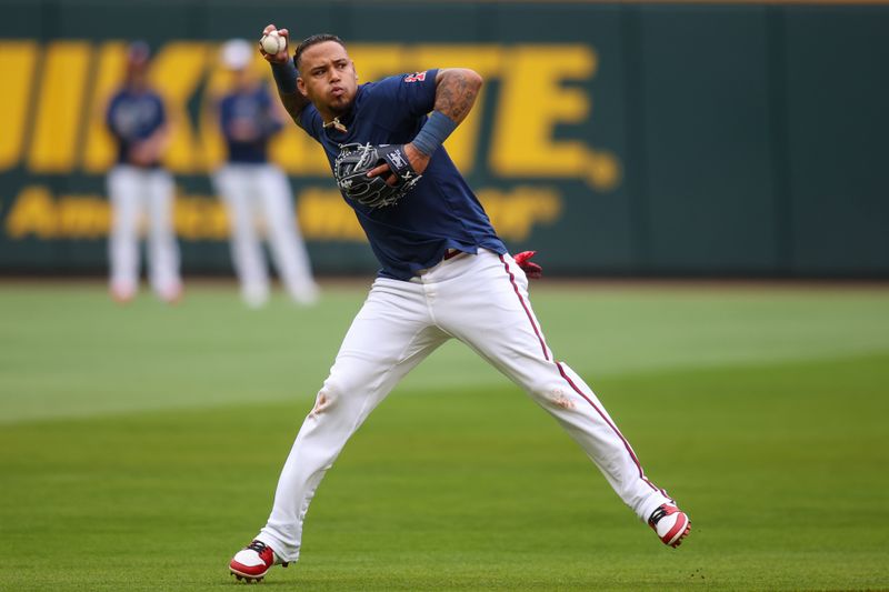 Apr 10, 2024; Atlanta, Georgia, USA; Atlanta Braves shortstop Orlando Arcia (11) throws to first during batting practice at Truist Park. The game against the New York Mets was postponed due to impending weather. Mandatory Credit: Brett Davis-USA TODAY Sports
