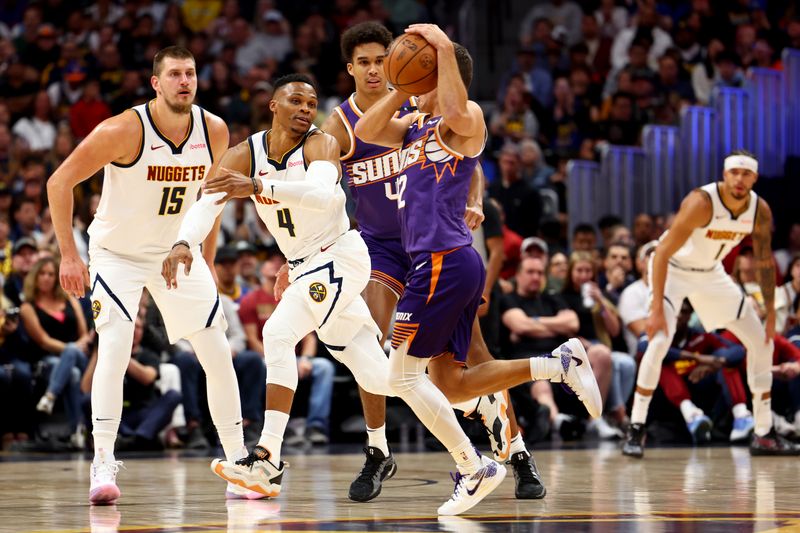 DENVER, COLORADO - OCTOBER 13: Russell Westbrook #4 of the Denver Nuggets defends against Collin Gillespie #21 of the Phoenix Suns at Ball Arena on October 13, 2024 in Denver, Colorado. NOTE TO USER: User expressly acknowledges and agrees that, by downloading and/or using this Photograph, user is consenting to the terms and conditions of the Getty Images License Agreement. (Photo by Jamie Schwaberow/Getty Images)