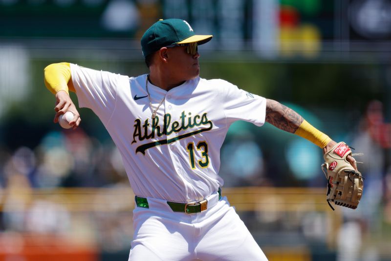 May 22, 2025; West Sacramento, California, USA; Athletics third baseman Gio Urshela (13) throws to first base for an out during the third inning against the Los Angeles Angels at Sutter Health Park. Mandatory Credit: Sergio Estrada-Imagn Images
