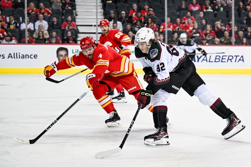 Jan 16, 2024; Calgary, Alberta, CAN; Arizona Coyotes center Logan Cooley (92) takes a shot as Calgary Flames defenseman Rasmus Andersson (4) tries to defend his zone during the first period at Scotiabank Saddledome. Mandatory Credit: Brett Holmes-USA TODAY Sports