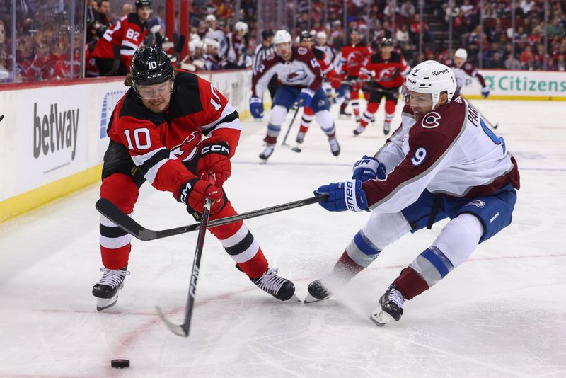 Feb 6, 2024; Newark, New Jersey, USA; New Jersey Devils right wing Alexander Holtz (10) and Colorado Avalanche left wing Zach Parise (9) battle for the puck during the first period at Prudential Center. Mandatory Credit: Ed Mulholland-USA TODAY Sports