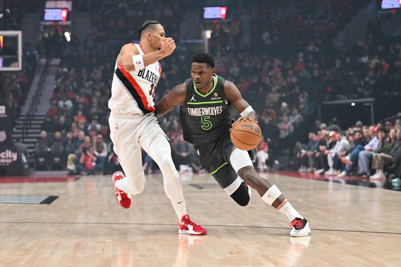 PORTLAND, OREGON - NOVEMBER 13: Anthony Edwards #5 of the Minnesota Timberwolves dribbles against Toumani Camara #33 of the Portland Trail Blazers during the first quarter of the game at Moda Center on November 13, 2024 in Portland, Oregon. NOTE TO USER: User expressly acknowledges and agrees that, by downloading and or using this photograph, User is consenting to the terms and conditions of the Getty Images License Agreement. (Photo by Alika Jenner/Getty Images)