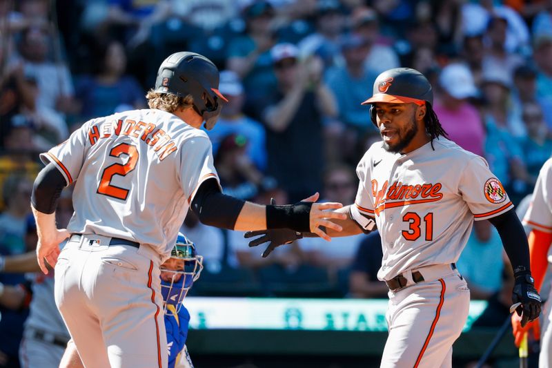 Aug 13, 2023; Seattle, Washington, USA; Baltimore Orioles center fielder Cedric Mullins (31) reacts with shortstop Gunnar Henderson (2) after hitting a two-run home run against the Seattle Mariners during the tenth inning at T-Mobile Park. Henderson scored a run on the hit. Mandatory Credit: Joe Nicholson-USA TODAY Sports