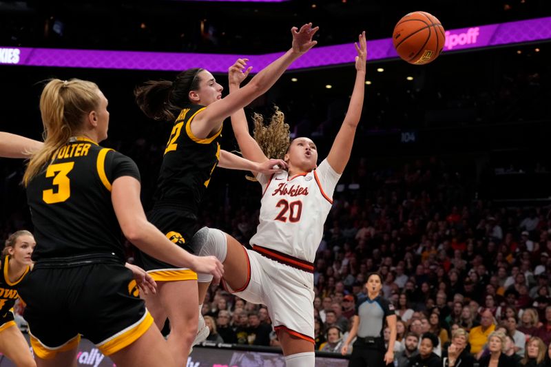 Nov 9, 2023; Charlotte, North Carolina, USA; Iowa Hawkeyes guard Caitlin Clark (22) tips the rebound away from Virginia Tech Hokies guard Olivia Summiel (20) during the first half at Spectrum Center. Mandatory Credit: Jim Dedmon-USA TODAY Sports