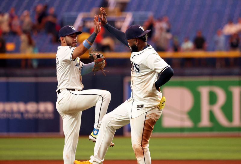 Sep 4, 2024; St. Petersburg, Florida, USA;  Tampa Bay Rays infielder Junior Caminero (13) is congratulated by Tampa Bay Rays shortstop Jose Caballero (7) after  they beat the Minnesota Twins at Tropicana Field. Mandatory Credit: Kim Klement Neitzel-Imagn Images