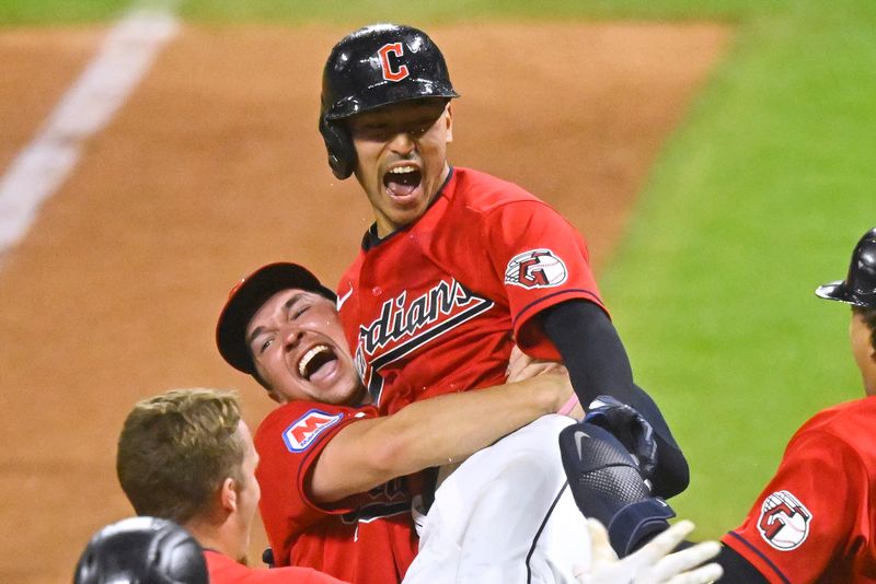 Sep 2, 2023; Cleveland, Ohio, USA; Cleveland Guardians left fielder Steven Kwan (38) is lifted in the air by right fielder Will Brennan (17) after hitting a game-winning RBI sacrifice fly against the Tampa Bay Rays in the eleventh inning at Progressive Field. Mandatory Credit: David Richard-USA TODAY Sports