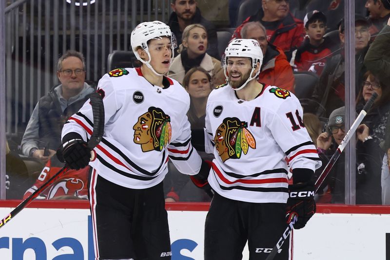 Jan 5, 2024; Newark, New Jersey, USA; Chicago Blackhawks center Jason Dickinson (16) celebrates his goal against the New Jersey Devils during the first period at Prudential Center. Mandatory Credit: Ed Mulholland-USA TODAY Sports