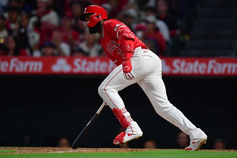 Apr 27, 2024; Anaheim, California, USA; Los Angeles Angels right fielder Jo Adell (7) hits an RBI single against the Minnesota Twins during the third inning at Angel Stadium. Mandatory Credit: Gary A. Vasquez-USA TODAY Sports