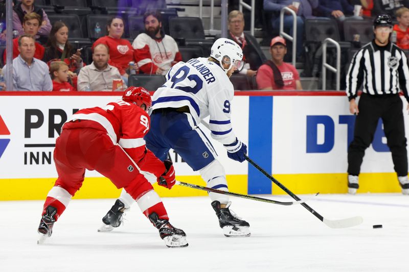 Oct 3, 2024; Detroit, Michigan, USA;  Toronto Maple Leafs left wing Alex Nylander (92) skates with the puck defended by Detroit Red Wings right wing Alex DeBrincat (93) in the third period at Little Caesars Arena. Mandatory Credit: Rick Osentoski-Imagn Images