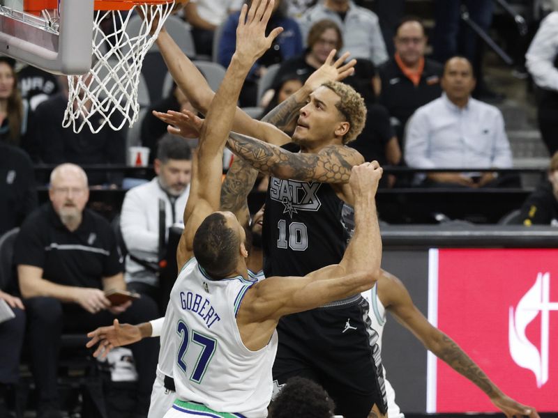 SAN ANTONIO, TX - JANUARY 27: Jeremy Sochan #10 of the San Antonio Spurs drives on Rudy Gobert #27 of the Minnesota Timberwolves in the first half at Frost Bank Center on January 27, 2024 in San Antonio, Texas. NOTE TO USER: User expressly acknowledges and agrees that, by downloading and or using this photograph, User is consenting to terms and conditions of the Getty Images License Agreement. (Photo by Ronald Cortes/Getty Images)