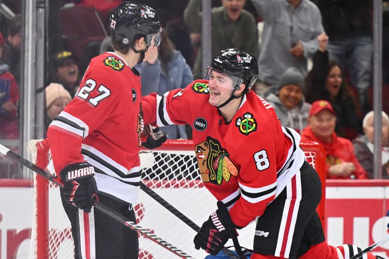 Dec 19, 2023; Chicago, Illinois, USA; Chicago Blackhawks forward Ryan Donato (8) celebrates with forward Lukas Reichel (27) after scoring a goal in the first period against the Colorado Avalanche at United Center. Mandatory Credit: Jamie Sabau-USA TODAY Sports