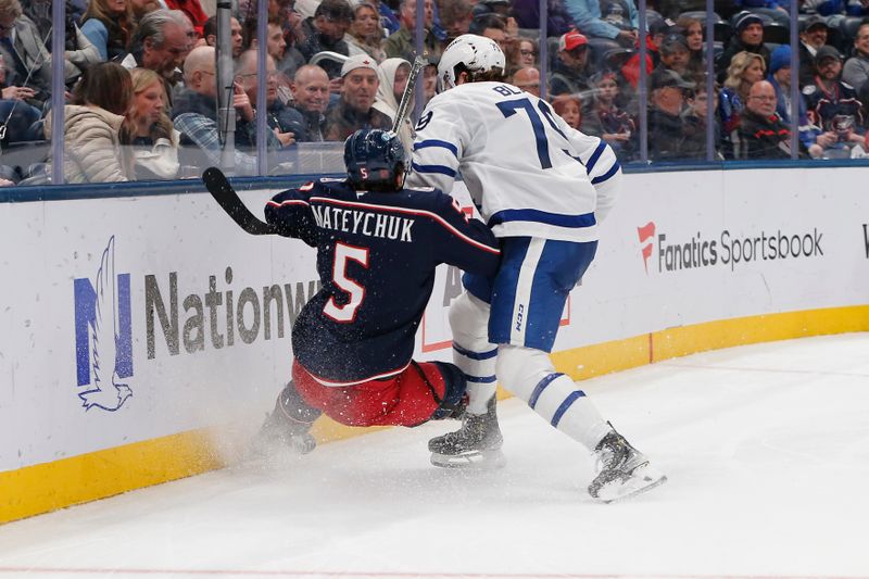 Oct 29, 2025; Columbus, Ohio, USA; Toronto Maple Leafs left wing Sammy Blais (79) checks Columbus Blue Jackets defenseman Denton Mateychuk (5) during the third period at Nationwide Arena. Mandatory Credit: Russell LaBounty-Imagn Images