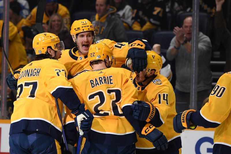 Nov 28, 2023; Nashville, Tennessee, USA; Nashville Predators right wing Michael McCarron (47) celebrates with teammates after scoring during the first period against the Pittsburgh Penguins at Bridgestone Arena. Mandatory Credit: Christopher Hanewinckel-USA TODAY Sports