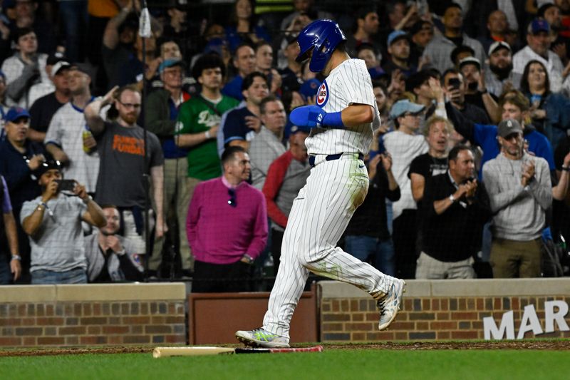 May 16, 2024; Chicago, Illinois, USA;  Chicago Cubs outfielder Seiya Suzuki (27) scores against the Pittsburgh Pirates during the eighth inning at Wrigley Field. Mandatory Credit: Matt Marton-USA TODAY Sports