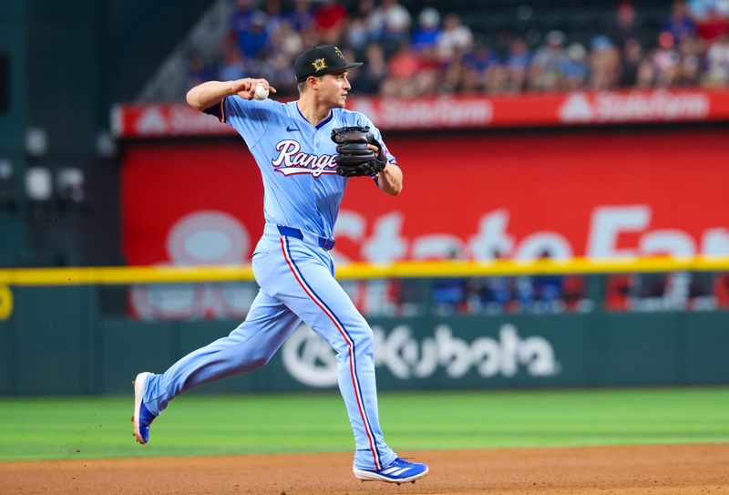 May 19, 2024; Arlington, Texas, USA; Texas Rangers shortstop Corey Seager (5) fields a ground ball and throws to first base during the eighth inning against the Los Angeles Angels at Globe Life Field. Mandatory Credit: Kevin Jairaj-USA TODAY Sports