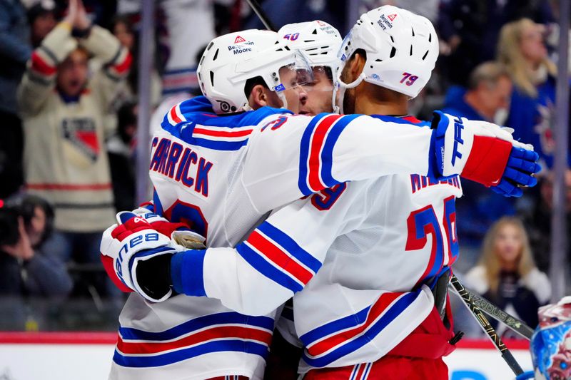 Jan 14, 2025; Denver, Colorado, USA; New York Rangers center Sam Carrick (39) celebrates his short handed goal with left wing Will Cuylle (50) and defenseman K'Andre Miller (79) in the first period against the Colorado Avalanche at Ball Arena. Mandatory Credit: Ron Chenoy-Imagn Images