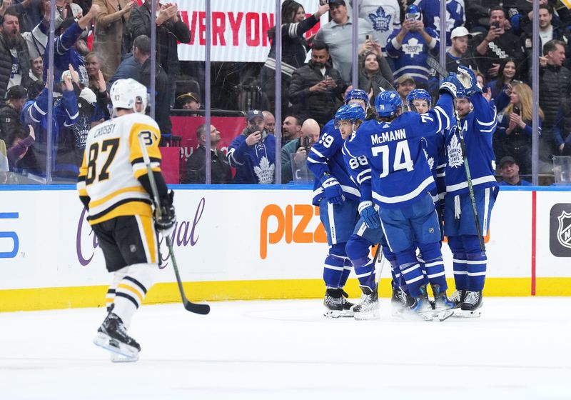 Apr 8, 2024; Toronto, Ontario, CAN; Toronto Maple Leafs defenseman Jake McCabe (22) scores the winning goal and celebrates with teammates against the Pittsburgh Penguins during the overtime period at Scotiabank Arena. Mandatory Credit: Nick Turchiaro-USA TODAY Sports