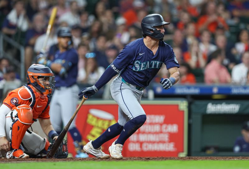 May 3, 2024; Houston, Texas, USA; Seattle Mariners third baseman Josh Rojas (4) hits a single during the eighth inning against the Houston Astros at Minute Maid Park. Mandatory Credit: Troy Taormina-USA TODAY Sports