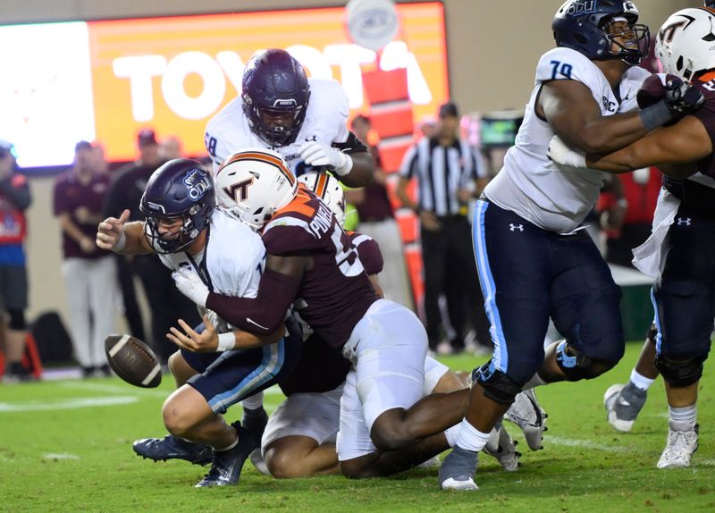 Sep 2, 2023; Blacksburg, Virginia, USA; Virginia Tech Hokies defensive lineman Antwaun Powell-Ryland (52)  forces Old Dominion Monarchs quarterback Grant Wilson (13)  to fumble ball but he would recover in time in the fourth quarter at Lane Stadium. Mandatory Credit: Lee Luther Jr.-USA TODAY Sports