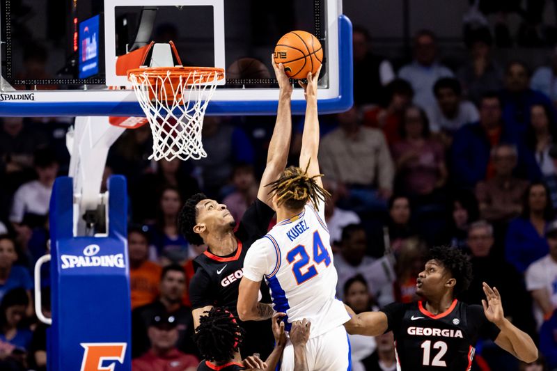 Jan 7, 2023; Gainesville, Florida, USA; Georgia Bulldogs center Frank Anselem (5) blocks the layup from Florida Gators guard Riley Kugel (24) during the first half at Exactech Arena at the Stephen C. O'Connell Center. Mandatory Credit: Matt Pendleton-USA TODAY Sports