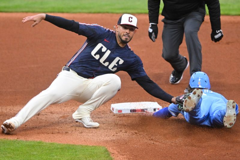 Apr 11, 2025; Cleveland, Ohio, USA; Kansas City Royals left fielder Drew Waters (8) is tagged out by Cleveland Guardians second baseman Gabriel Arias (13) while attempting to steal second base in the fourth inning at Progressive Field. Mandatory Credit: David Richard-Imagn Images