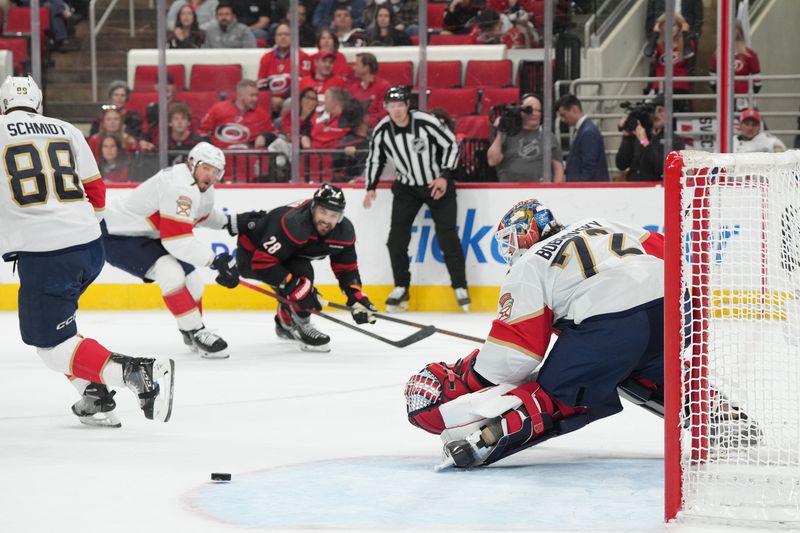 May 22, 2025; Raleigh, North Carolina, USA;  Florida Panthers goaltender Sergei Bobrovsky (72) defends against a shot by Carolina Hurricanes forward William Carrier (28) during the third period in game two of the Eastern Conference Final of the 2025 Stanley Cup Playoffs at Lenovo Center. Mandatory Credit: James Guillory-Imagn Images